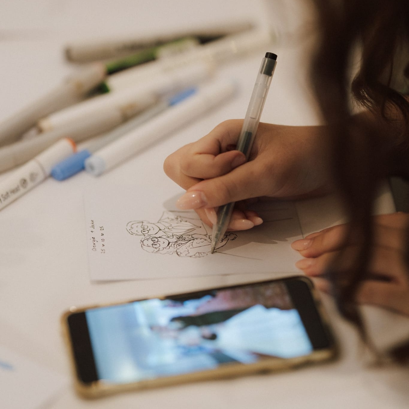 Emma drawing at a table